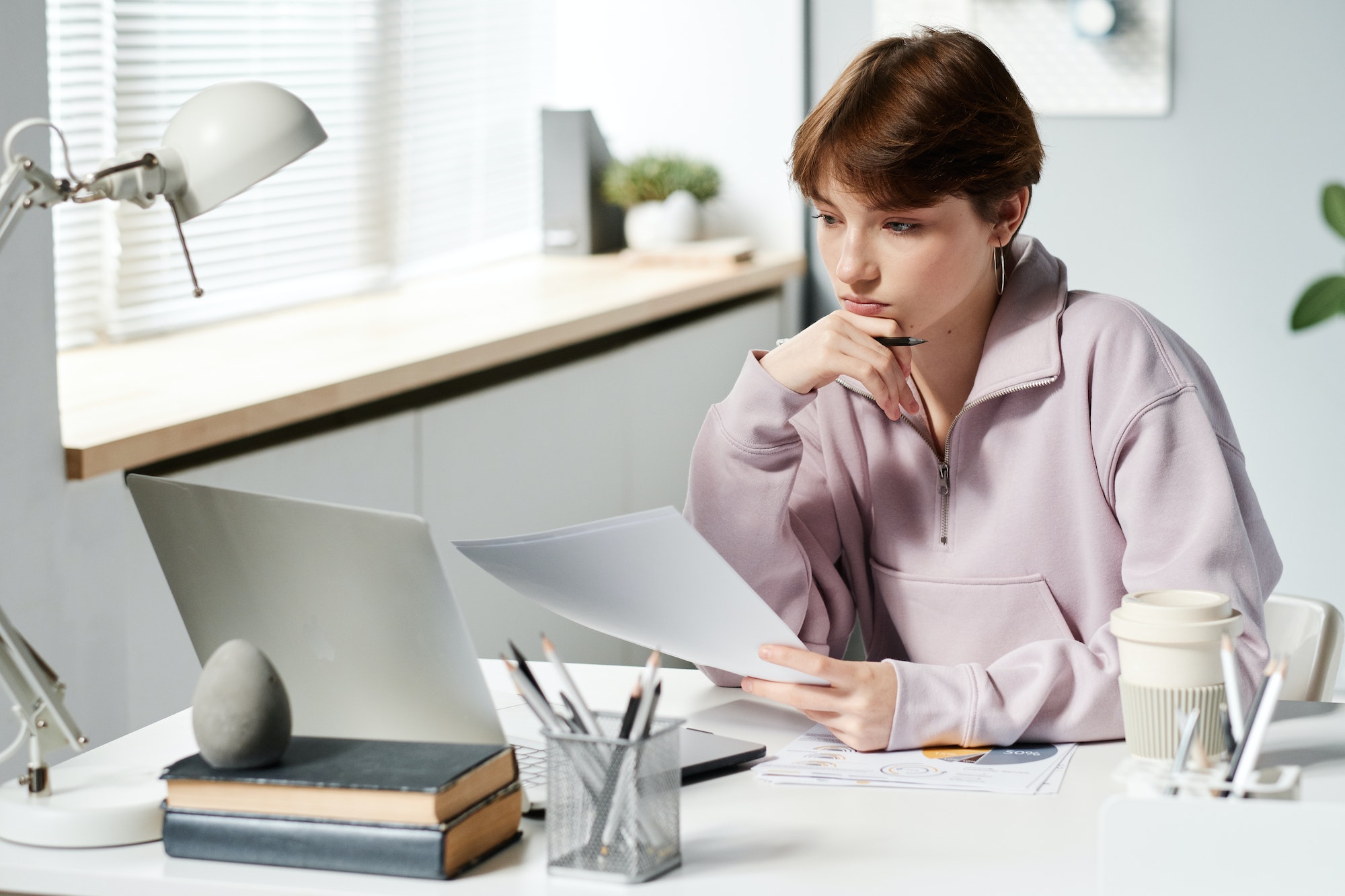 Girl in hoodie analyzing budget