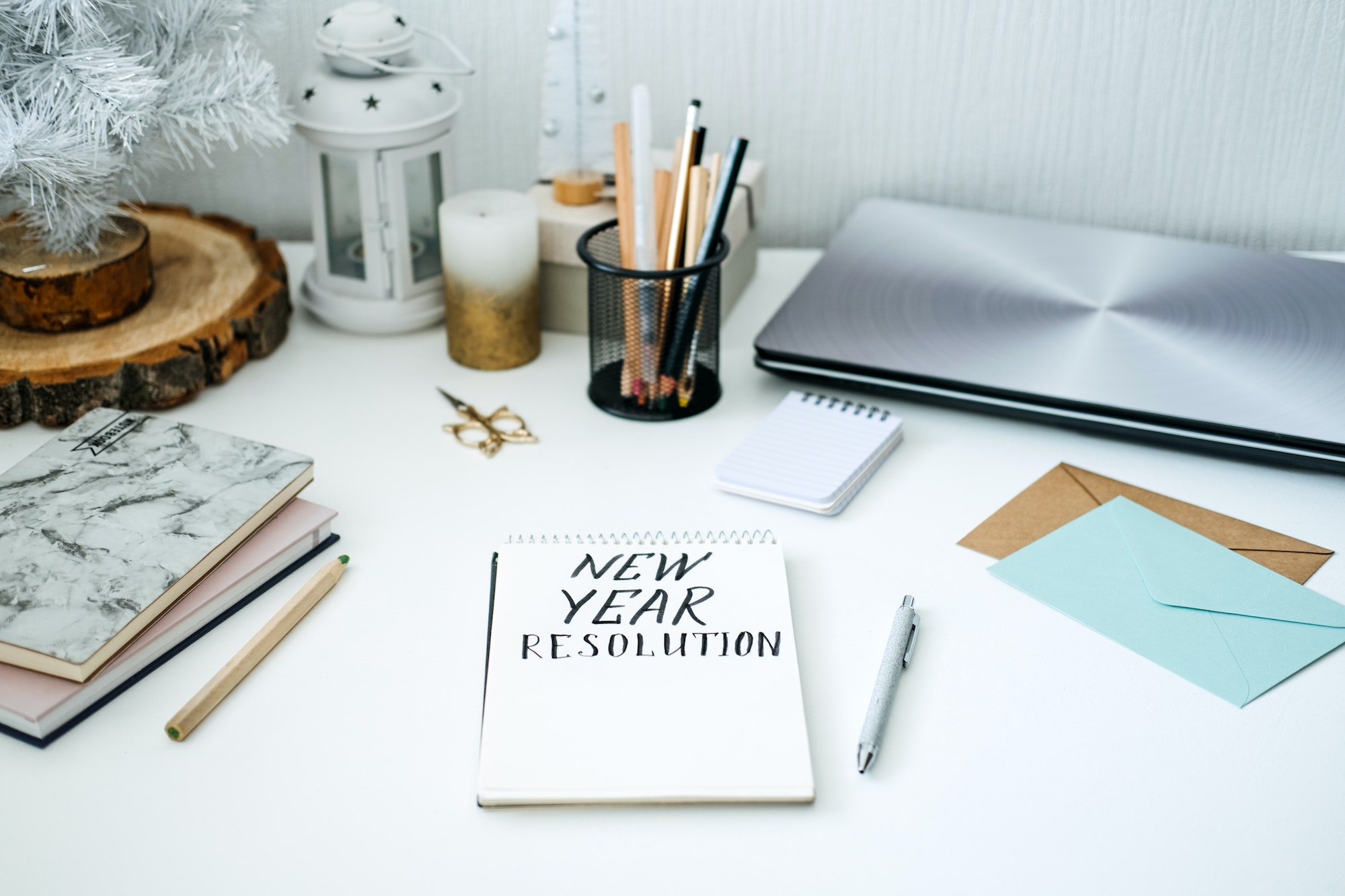 New year resolution, New goals. Handwritten Text New year resolution in open notepad on the table